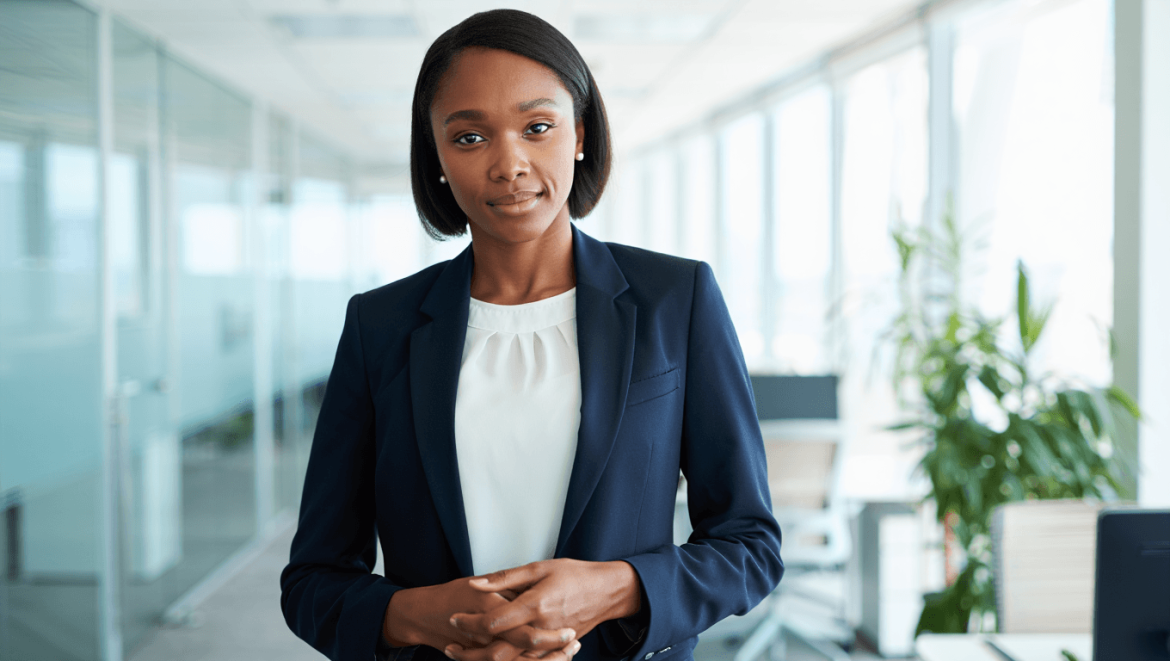 Femme souriante en pull jaune pointant vers la droite sur fond bleu, pour illustrer une formation en gestion d’entreprise proposée par CréActifs.