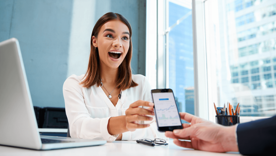 Illustration of a bank teller window sliding a stack of cash toward an open hand, representing a bank paying a cash bonus to a new account holder.