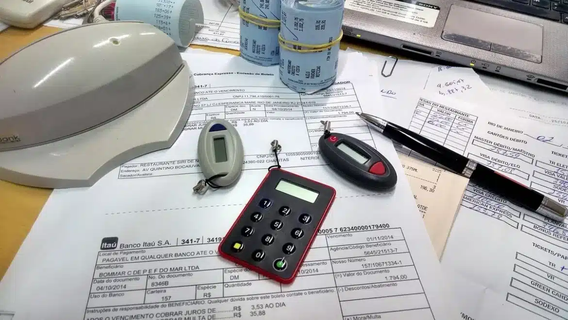 Person anonyme classant des documents et utilisant une calculatrice à une table en plein jour
